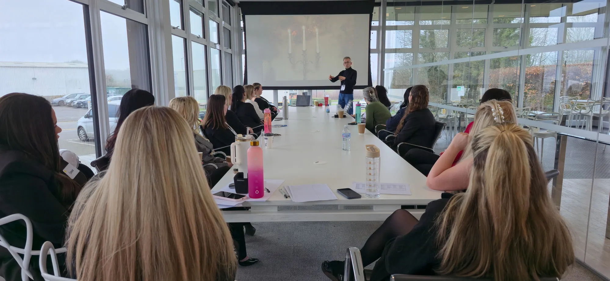Andrew Pain leading a workshop for a team seated around a boardroom table