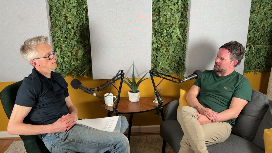 Andrew Pain recording a podcast conversation at the microphone