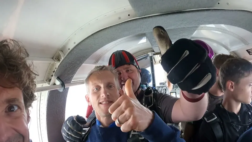 Andrew in the plane moments before his charity skydive, thumbs up